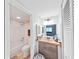Bathroom featuring a vanity with vessel sink, drawers, and a view into the shower area at 5915 Sea Ranch Dr # 408, Hudson, FL 34667