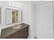 Bathroom featuring a vanity with vessel sink, decorative mirror, and updated lighting at 5915 Sea Ranch Dr # 408, Hudson, FL 34667