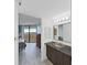 Bathroom includes modern sink and vanity with access to the bedroom and views from the balcony at 5915 Sea Ranch Dr # 408, Hudson, FL 34667
