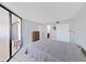Cozy bedroom with a balcony, closet, and a glimpse into the en-suite bathroom at 5915 Sea Ranch Dr # 408, Hudson, FL 34667