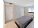 Bedroom features gray wood-look floors, closet, and an AC unit at 5915 Sea Ranch Dr # 408, Hudson, FL 34667