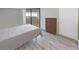 Serene bedroom features light floors, closet space and sliding door access to balcony with a water view at 5915 Sea Ranch Dr # 408, Hudson, FL 34667