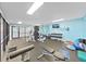 Well-equipped gym featuring modern exercise equipment and a TV for entertainment at 5915 Sea Ranch Dr # 408, Hudson, FL 34667