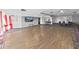 Spacious hall featuring hardwood floors, chairs, and a TV for entertainment at 5915 Sea Ranch Dr # 408, Hudson, FL 34667