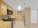 Charming kitchen features wood cabinets and laminate countertops, creating a warm atmosphere at 5915 Sea Ranch Dr # 408, Hudson, FL 34667