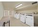 Well-maintained laundry room with multiple washers and convenient folding area at 5915 Sea Ranch Dr # 408, Hudson, FL 34667