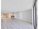 Bright living room with hardwood floors, a kitchen, and ample natural light at 5915 Sea Ranch Dr # 408, Hudson, FL 34667
