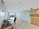 Spacious living room with an open floor plan, wood-look floors, and a balcony at 5915 Sea Ranch Dr # 408, Hudson, FL 34667