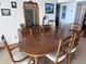 Rustic wooden dining table with six chairs in a bright dining area at 6020 Shore S Blvd # 301, Gulfport, FL 33707