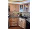 Modern kitchen with granite counters, wood cabinets, and black appliances at 6020 Shore S Blvd # 301, Gulfport, FL 33707