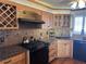 Modern kitchen with granite counters, wood cabinets, and black appliances at 6020 Shore S Blvd # 301, Gulfport, FL 33707
