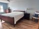 Main bedroom with hardwood floors and a sleigh bed at 6020 Shore S Blvd # 301, Gulfport, FL 33707