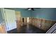 Bedroom featuring damage to walls, dark floors, ceiling fan and a closet area at 6906 Quail Hollow Blvd, Wesley Chapel, FL 33544