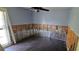 Bedroom featuring damage to walls, dark floors, and a ceiling fan at 6906 Quail Hollow Blvd, Wesley Chapel, FL 33544