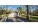 Exterior angle of home shows an attached garage, gated drive and simple architecture at 6906 Quail Hollow Blvd, Wesley Chapel, FL 33544