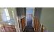 Hallway with view to a bathroom, damaged walls, and dark floors at 6906 Quail Hollow Blvd, Wesley Chapel, FL 33544