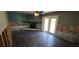 Living room featuring a fireplace, damage to walls, dark floors, and glass doors to the backyard at 6906 Quail Hollow Blvd, Wesley Chapel, FL 33544