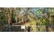 A view of a vacant parcel of land with a chain link fence around the border at 6906 Quail Hollow Blvd, Wesley Chapel, FL 33544
