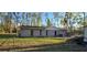 Rear exterior view of the home shows a fenced yard and minimalist backyard at 6906 Quail Hollow Blvd, Wesley Chapel, FL 33544