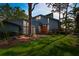 Gray house with orange door, brick walkway, and lush green lawn at 750 71St S Ter, St Petersburg, FL 33705