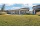 Large grassy backyard with a view of the home's covered patio at 8614 Mercator Ct, Parrish, FL 34219