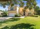 Two-story house with attached garage and lush green lawn at 9701 Hidden Cove Ct, Tampa, FL 33618