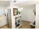 Kitchen entry with glass-front cabinets and bench at 9950 47Th N Ave # 104, St Petersburg, FL 33708