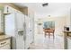 Kitchen with white refrigerator, access to backyard, and breakfast nook at 1016 Standing Reed Pl, Wesley Chapel, FL 33543