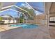 Relaxing kidney-shaped pool with a screened enclosure at 11927 Middlebury Dr, Tampa, FL 33626