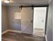 Interior view featuring a white barn door and light grey walls at 1221 E Curtis St, Tampa, FL 33603