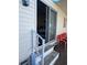 Sliding glass doors leading to a patio with red chairs at 13225 101St St # 425, Largo, FL 33773