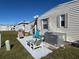 Small paved patio area with seating and AC unit at 13225 101St St # 425, Largo, FL 33773