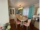 Well-lit dining area featuring a marble-top table, six chairs, and a built-in hutch at 13225 101St St # 425, Largo, FL 33773