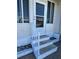 Steps leading to the front door of the home with white railing at 13225 101St St # 425, Largo, FL 33773