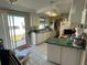 Kitchen features white cabinets, green countertops and appliances at 13225 101St St # 425, Largo, FL 33773