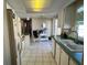 Open concept kitchen with white cabinets and a breakfast bar at 13225 101St St # 425, Largo, FL 33773