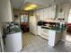 Bright kitchen with white cabinets and green countertops at 13225 101St St # 425, Largo, FL 33773
