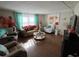 Open living area with comfortable seating, a coffee table, and large artwork at 13225 101St St # 425, Largo, FL 33773
