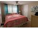 Large main bedroom with a king-size bed, ceiling fan, and decorative wall art at 13225 101St St # 425, Largo, FL 33773