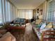 Bright sunroom with wicker furniture, large windows, and wood-look floors at 13225 101St St # 425, Largo, FL 33773