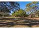 Spacious front yard with mature trees provides shade and privacy at 14028 Hurricane Dr, Weeki Wachee, FL 34614