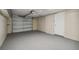 Spacious garage with overhead storage and ample space for parking and storage at 1424 Basswood Dr, Holiday, FL 34690