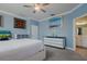 Relaxing bedroom with a comfortable bed, dresser, and access to a bathroom at 16819 Shell Bay Dr, Land O Lakes, FL 34638