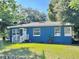 Charming blue house with a well-maintained lawn at 1719 E Cayuga St, Tampa, FL 33610