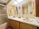 Double sink bathroom with a shower and updated vanity at 18675 Us Highway 19 N # 232, Clearwater, FL 33764