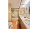Clean bathroom with double sinks, shower/tub combo, and wood cabinets at 18675 Us Highway 19 N # 232, Clearwater, FL 33764