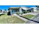 Single-wide manufactured home with carport and landscaped front yard at 18675 Us Highway 19 N # 232, Clearwater, FL 33764