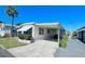 Single-wide manufactured home with carport and golf cart at 18675 Us Highway 19 N # 232, Clearwater, FL 33764