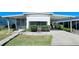 Single-wide manufactured home with carport and landscaped front yard at 18675 Us Highway 19 N # 232, Clearwater, FL 33764