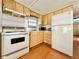 Small kitchen with white appliances and wood cabinets at 18675 Us Highway 19 N # 232, Clearwater, FL 33764